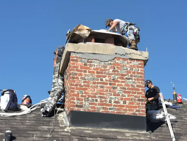 Northborough Chimney Sweep installing a custom chimney crown in Northborough, MA